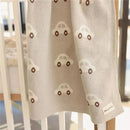 100% luxury cotton swaddle blanket in cream color, featuring small car patterns and a Bleu La La label.