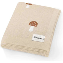Luxury cotton baby blanket from Bleu La La featuring mushroom patterns on a beige background.