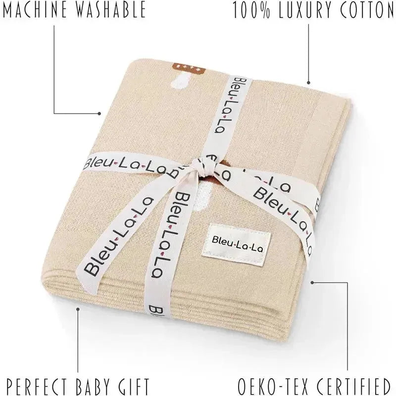 100% luxury cotton baby swaddle blanket by Bleu La La, in a mushroom camel color, tied with a decorative ribbon.