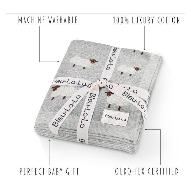 100% luxury cotton baby swaddle blanket by Bleu La La, featuring a sheep design, packaged with a ribbon and care details.