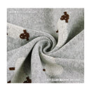 Luxury cotton swaddle blanket in gray, featuring sheep patterns, described as warm yet lightweight and machine washable.