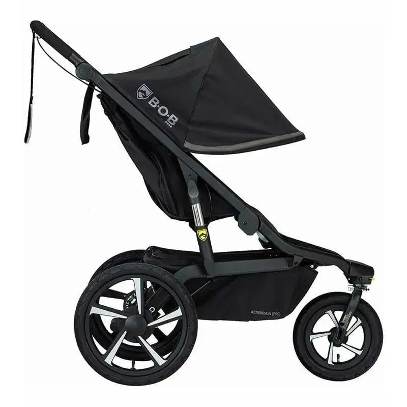All-weather jogging stroller featuring a sleek black design, adjustable canopy, and large rear wheels for rugged terrain.