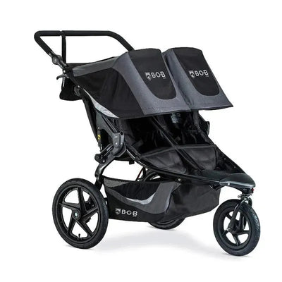 Double BOB jogging stroller in black with two seats, adjustable canopies, and sturdy wheels for outdoor use.