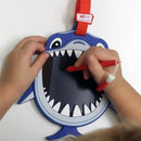 Child drawing on the Boogie Board Sketch Pals Ocean Friends - Clark Shark, a shark-shaped drawing tablet with a red stylus.