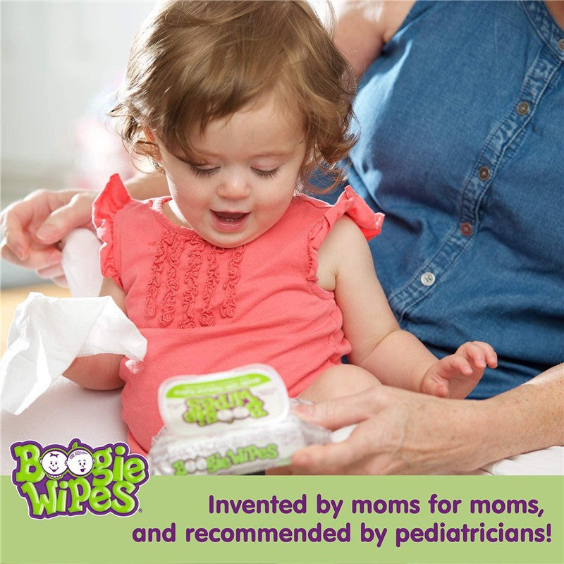 Toddler in a coral shirt excitedly reaching for Boogie Wipes, a pack of saline nose wipes, while being assisted by an adult.