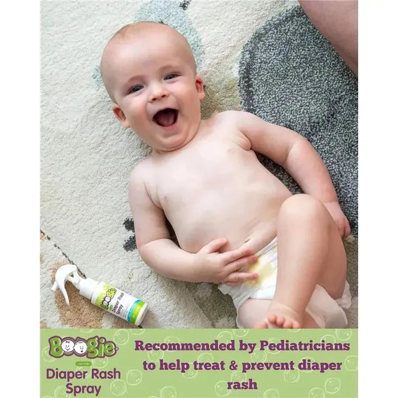 Smiling baby laying on a soft surface, with Boogie Wipes Diaper Rash Spray nearby, promoting diaper rash treatment.