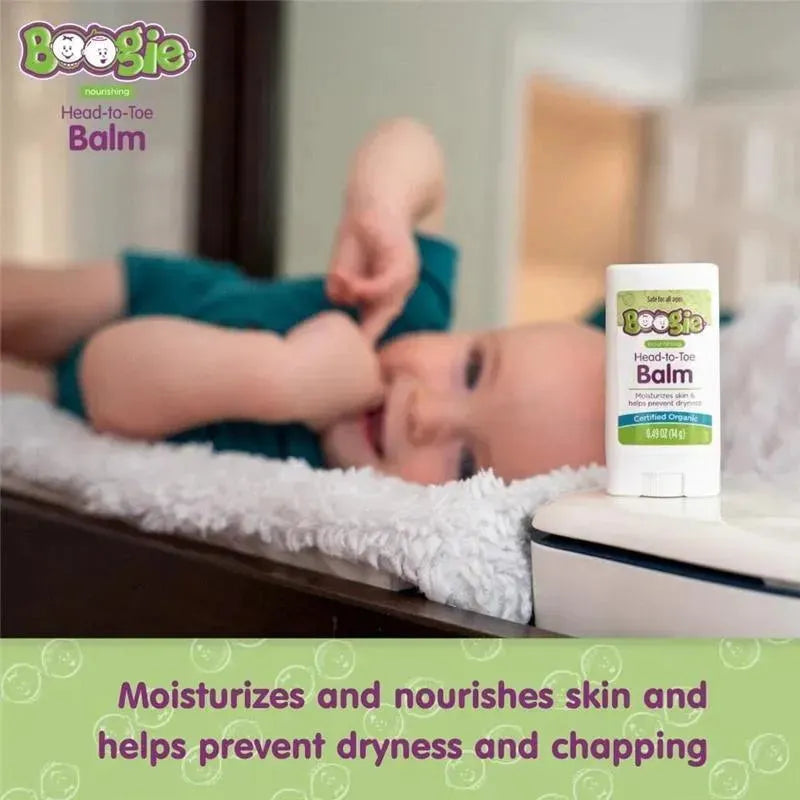 Baby lying on a cozy surface next to Boogie Wipes Head-To-Toe Balm, highlighting its moisturizing benefits.