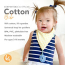 Cotton bib featuring a yellow bandana design with a pacifier holder, worn by a smiling toddler in a striped shirt.