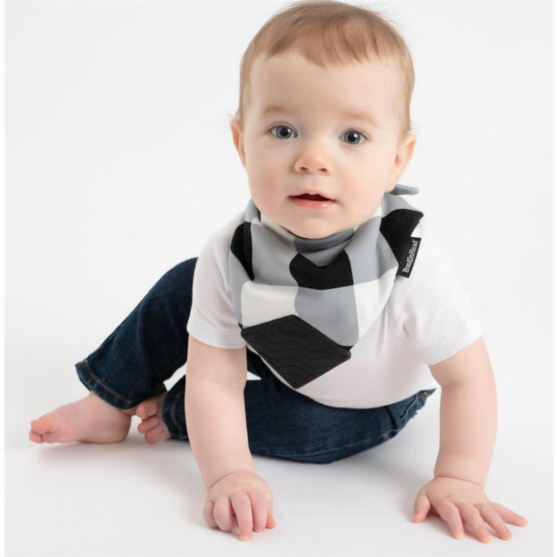 Baby wearing a BooginHead Buffalo Check Bandana Teether & Pacigrip Bib, sitting on the floor in denim jeans.