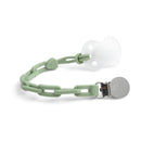 Sage green silicone pacifier clip with a white pacifier, featuring a metal clip for attachment.