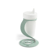 Silicone Sippigrip cup in green sage color with a flexible, textured holder designed to securely grip and prevent spills.