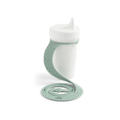 Silicone Sippigrip cup in green sage color with a flexible, textured holder designed to securely grip and prevent spills.