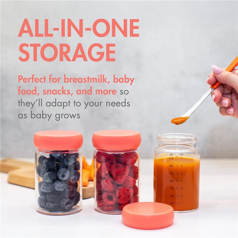 Three clear glass jars with orange lids filled with blueberries, raspberries, and baby food, with a hand holding a spoon.