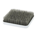 Boon GRASS countertop drying rack in grey with a square base and numerous upright flexible pegs for drying dishes.