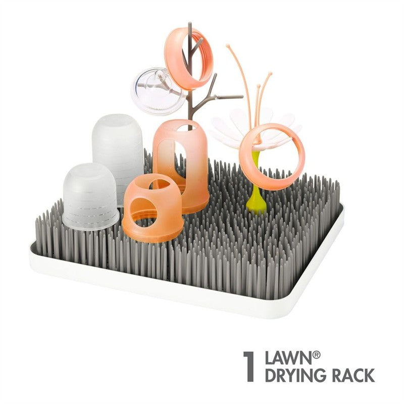 Gray and white countertop drying rack featuring colorful accessories for drying baby bottles and items.