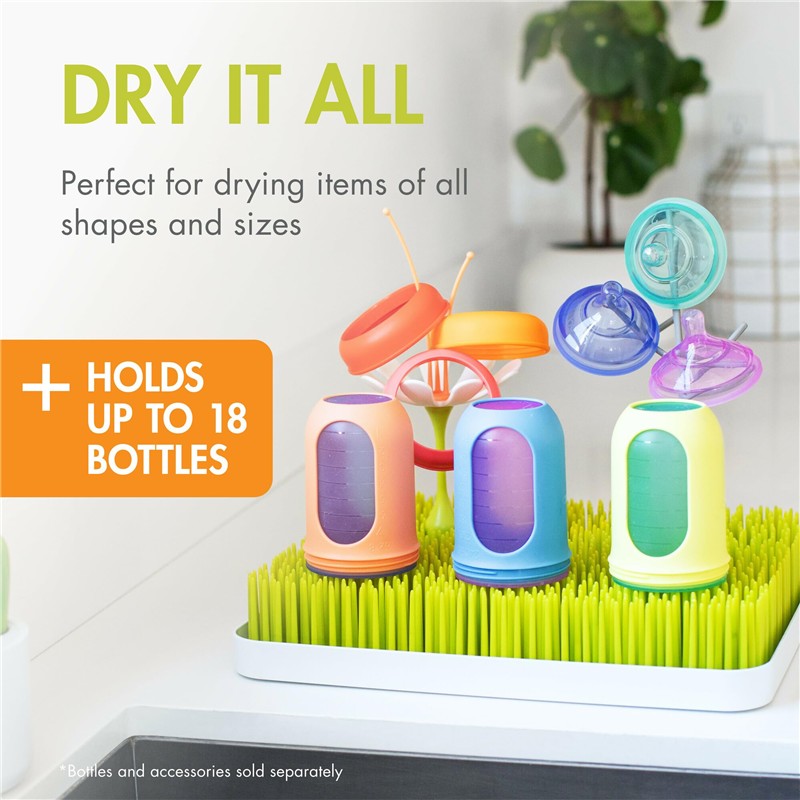 Countertop drying rack in green and white with colorful bottle holders, designed to dry up to 18 bottles of various shapes.