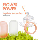 Boon LAWN drying rack features a flower design holding bottle parts and pacifiers, with an orange and green color scheme.