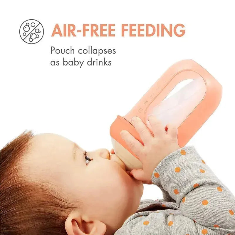 Baby using a Boon Nursh silicone bottle in peach, featuring air-free feeding and a collapsible pouch.