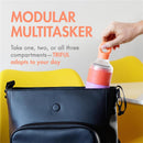 Boon Triful Baby Formula Dispenser in pink is being placed into a black bag, highlighting its modular compartments.