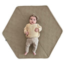 Boppy Foam Play Mat in Natural-Maze Tan with a baby lying on it, featuring a non-skid backing for safe play.