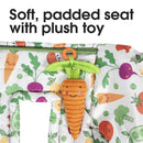 Soft, padded high chair cover featuring a plush carrot toy and colorful vegetable patterns.