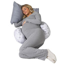 Pregnant woman in gray sleepwear resting with a Boppy Side Sleeper pillow featuring a gray and white falling leaves design.