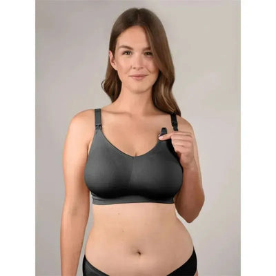 Black seamless nursing bra being modeled by a woman, showing adjustable straps and easy access clips.