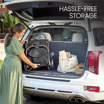 A woman placing a Britax Juniper Compact On-The-Go Stroller in the trunk of an SUV, demonstrating hassle-free storage.