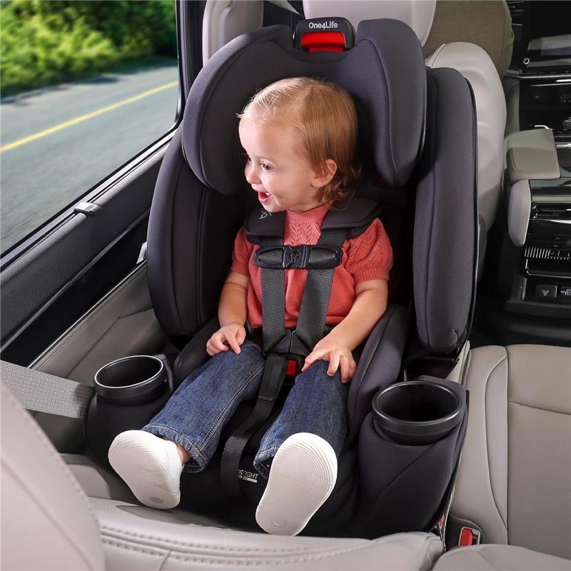 Child smiling while seated in a Britax One4Life All in One Convertible Car Seat, Raven Black, secured with harness straps.