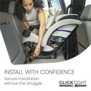 Woman installing a Britax One4Life Slim All-in-One Car Seat, Sea Foam, in a vehicle with instructional labels visible.
