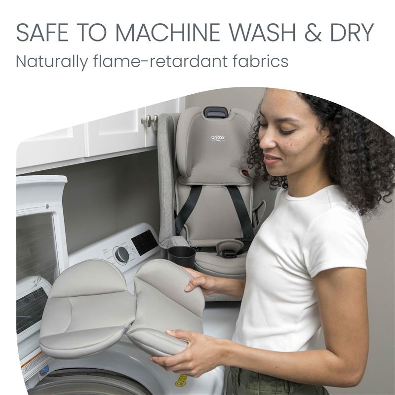 Britax One4Life Slim All-in-One Car Seat in Sea Foam, with removable parts being held by a woman near a washing machine.
