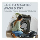 Woman placing a car seat insert into a washing machine, promoting machine washability and flame-retardant fabrics.