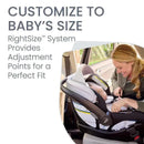 A woman smiles while adjusting a Britax Willow S Infant Car Seat with Alpine Anti-Rebound Base in a vehicle.