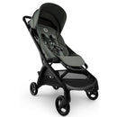 Compact Bugaboo Butterfly 2 stroller in black and forest green, featuring a padded seat, five-point harness, and spacious undercarriage.