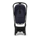 Bugaboo Butterfly 2 Plus Complete Stroller in Deep Indigo, viewed from the back, showcasing its compact design and storage basket.