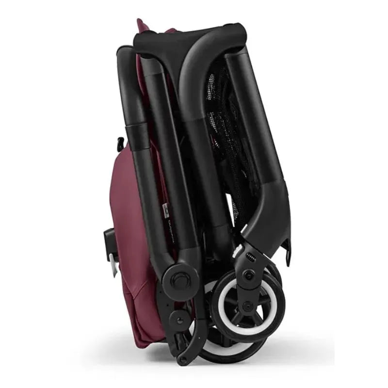Compact Bugaboo Butterfly stroller in dark cherry, folded for easy storage or transport, showcasing its sleek design.