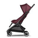 Compact Bugaboo Butterfly stroller in dark cherry, featuring a reclining seat, adjustable canopy, and a black frame.
