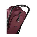 Compact Bugaboo Butterfly stroller in Dark Cherry with a black handle and adjustable harness, showcasing the rear view.