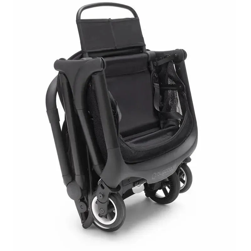 Compact black and forest green Bugaboo Butterfly stroller, folded with visible wheels and a mesh seat.