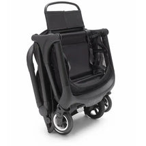 Compact black and forest green Bugaboo Butterfly stroller, folded with visible wheels and a mesh seat.
