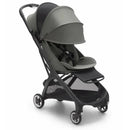Compact Bugaboo Butterfly stroller in black and forest green, featuring a canopy, safety harness, and mesh storage basket.