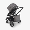 Grey melange Bugaboo changing bag attached to the back of a stroller, showcasing a modern design and storage capability.