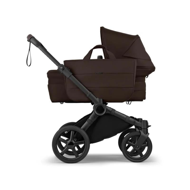 Complete Bugaboo Donkey 6 stroller in black and cocoa brown with a bassinet attached, showcasing its sleek design and spacious storage.