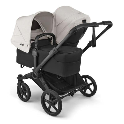 Bugaboo Donkey 6 Complete Stroller in black with a beige canopy and a large underseat storage basket.