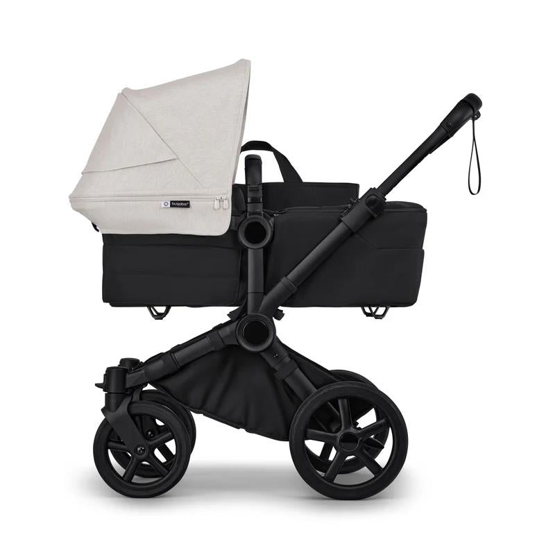Bugaboo Donkey 6 Complete Stroller in Black/Heritage Black with a beige canopy, featuring a sleek design and large wheels.