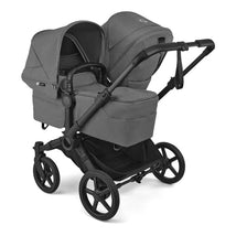 Bugaboo Donkey 6 Complete Stroller in black and moon grey, featuring two expandable seats and a spacious storage basket.