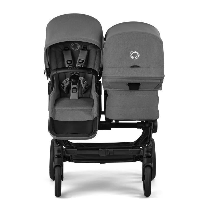 Bugaboo Donkey 6 Complete Stroller in black and moon grey, featuring two seating units with adjustable canopies and harnesses.