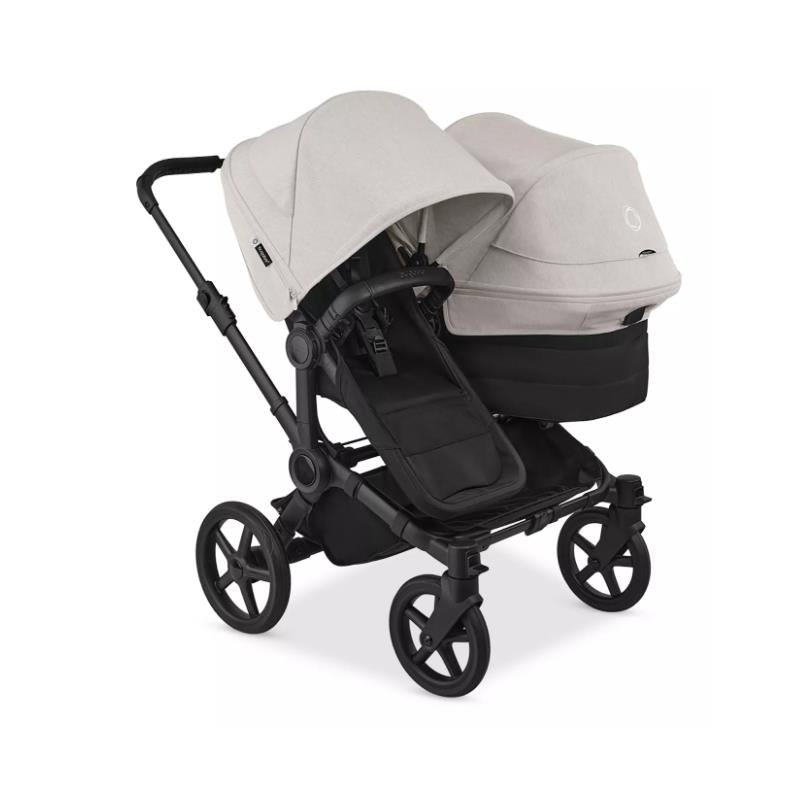 Bugaboo Donkey 6 Sibling Seat in Heritage Black and Misty White with two sun canopies and a spacious seating area.