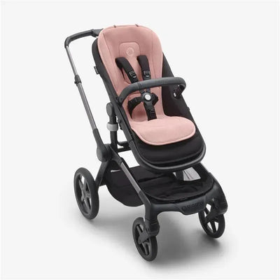 Bugaboo Dual Comfort Seat Liner in Morning Pink, designed for stroller comfort, displayed on a black stroller frame.