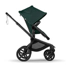 Bugaboo Fox 5 Renew stroller in Black with Fern Green fabric; features a sleek frame and large wheels for easy maneuvering.
